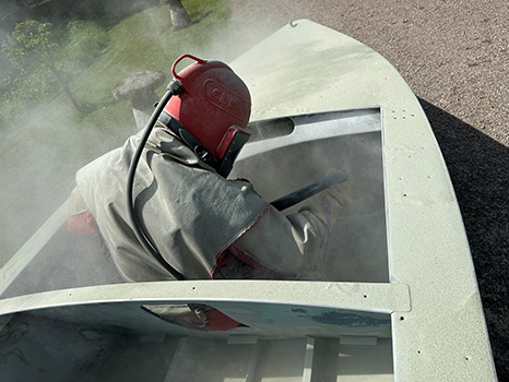 Blasting a metal boat